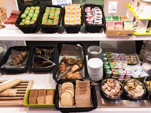 a refrigerator filled with lots of different types of food at ibis budget Orange Centre in Orange
