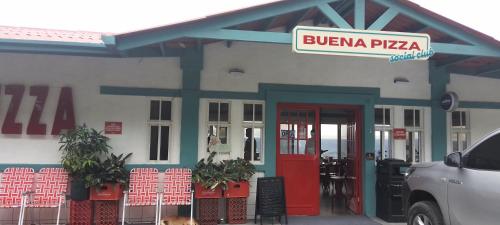 a building with a red door and a sign on it at Luxury apartmеnt with private terrace in Altos del Maria in Sorá