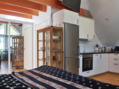a kitchen with a refrigerator and a stove at Akersberga Apartment close to Sea in Åkersberga