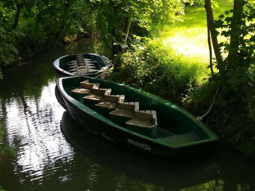 two boats are docked on a river at ibis budget Niort - La Crèche in La Creche