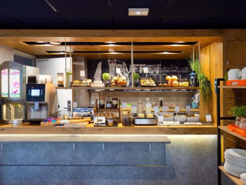 a kitchen with a counter with food on it at Ibis Budget Manosque Cadarache in Manosque