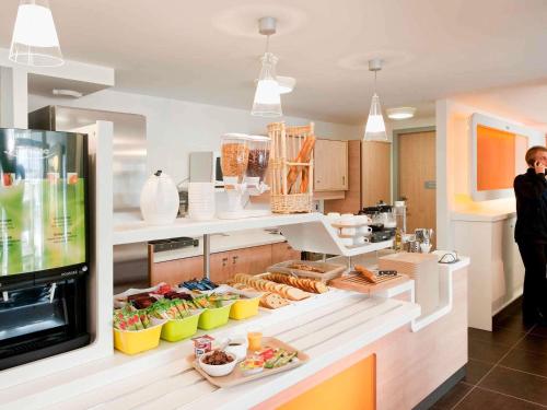 a kitchen with a counter with food on it at ibis budget Amberieu en Bugey/Chateau Gaillard A42 in Château-Gaillard