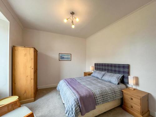 a bedroom with a bed and a chandelier at Glenfyne Apartment - Uk49318 in Ardrishaig