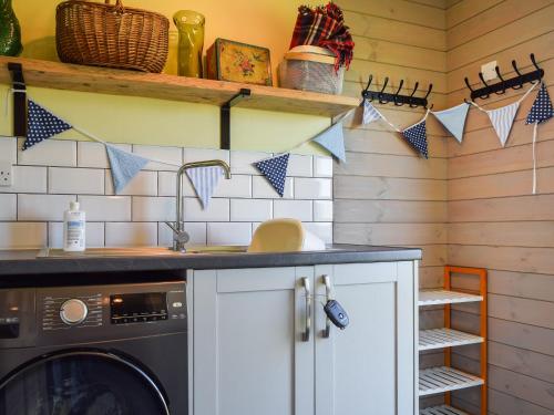 a laundry room with a washer and dryer at The Cabin - Uk49767 in Northampton