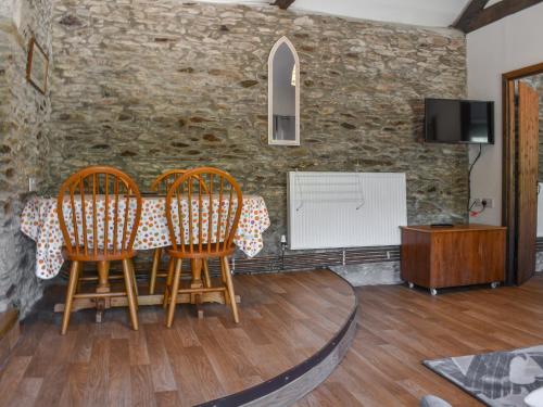 a dining room with two chairs and a table at Byre Cottage - Uk50028 in Liskeard