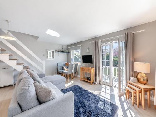 a living room with a couch and a tv at Water's Edge Holiday Home in Beadnell