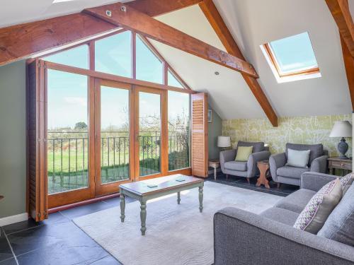 a living room with a couch and a table at The Roost in Saint Breward