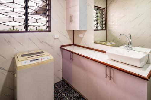 a small bathroom with a sink and a counter at A1 Homestay in Suva