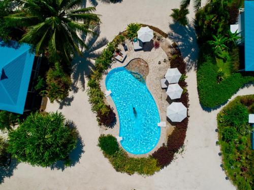 an overhead view of a swimming pool in the sand at a resort at Opoa Beach Hotel in Opoa