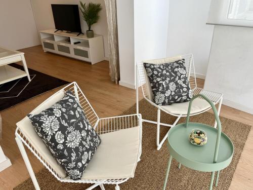 a living room with two chairs and a table at Lovely Estoril Apartment in Estoril