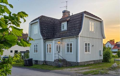 a white house with a black roof at Gorgeous Home In Tingsryd With Kitchen in Tingsryd