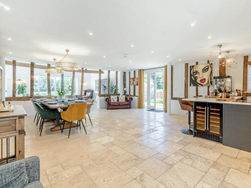 a dining room and living room with a dining table at Granary Barn in Ashwellthorpe