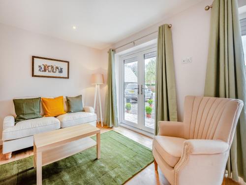 a living room with a couch and a chair at Dairy Cottage-Ukc5158 in Shootend