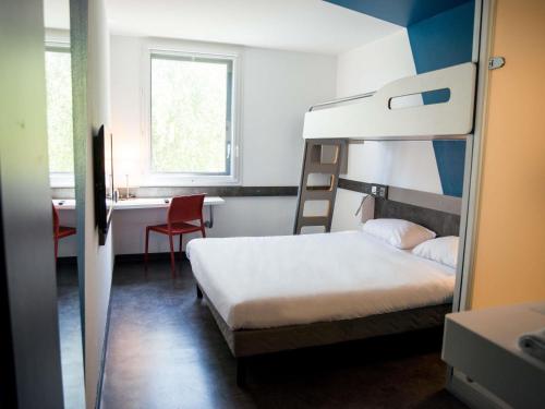 a bedroom with a bunk bed and a desk at Ibis Budget Archamps Porte de Genève in Archamps