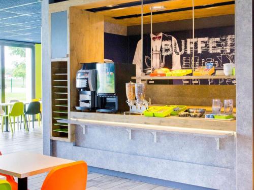 a kitchen with a counter with a coffee maker at ibis budget Montceau les Mines in Montceau-les-Mines