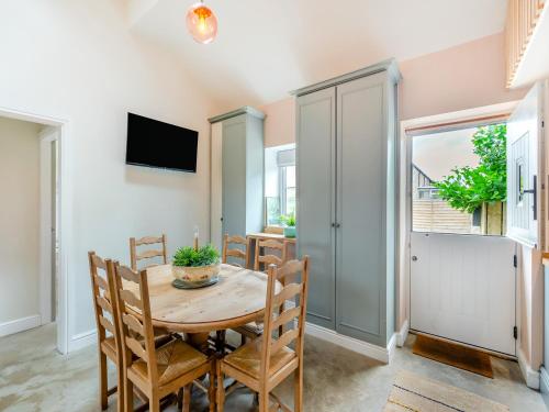 a dining room with a wooden table and chairs at The Coop in West Bradford