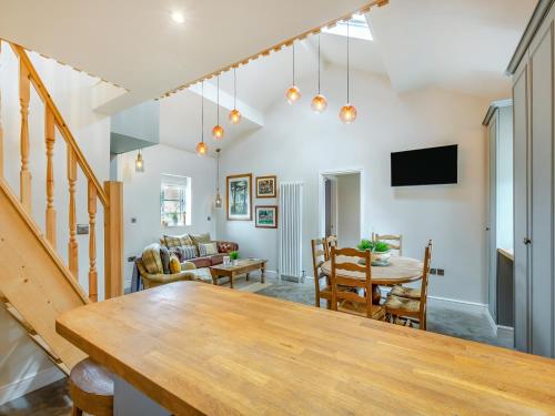 a living room with a table and a dining room at The Coop in West Bradford