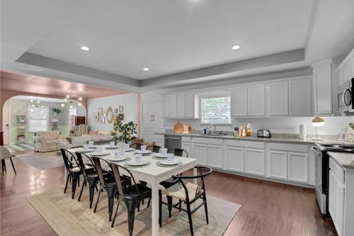 a kitchen and dining room with a table and chairs at Spacious Oasis 1 mi to Riverwalk in San Antonio