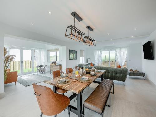 a dining room and living room with a table and chairs at Hillside House in Berwick-Upon-Tweed