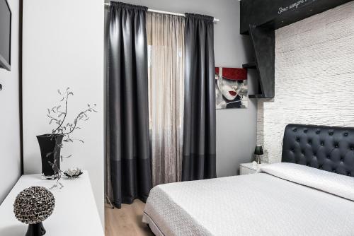 a bedroom with a bed and a window with a mask at Ariston Suite in Piazza Armerina