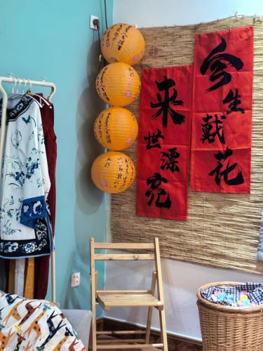a room with a chair and paintings on the wall at 厦门哈哈虎客栈 in Xiamen