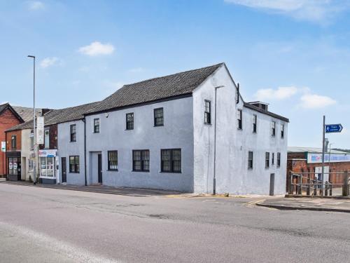 an old white building on the side of a street at Apartment 1 - Uk50135 in Stoke on Trent