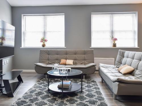 a living room with a couch and a table at Apartment 1 - Uk50135 in Stoke on Trent