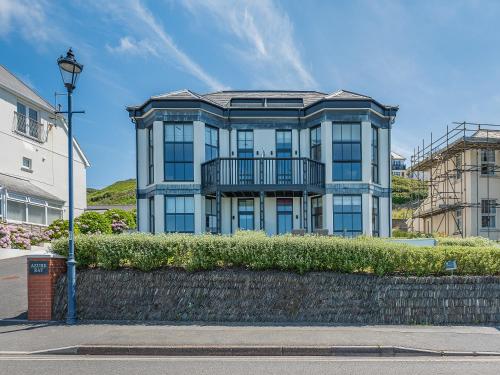 a large blue building on a street with a street light at Azure Bay in Woolacombe