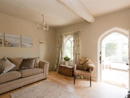 a living room with a couch and a chair at Dell Cottage in Mundesley