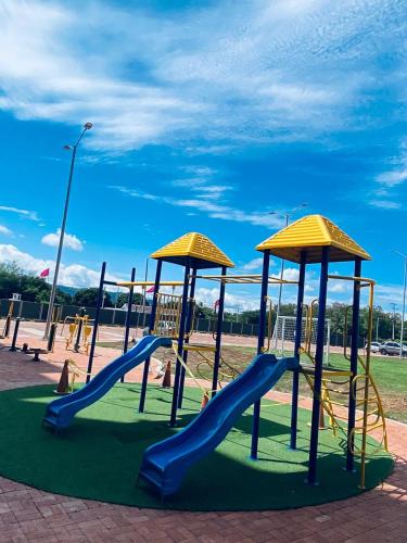 a playground with a slide and a slideintend at Apartamiento Ricaurte -Colombia in Girardot