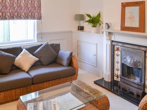 a living room with a couch and a fireplace at Beachcomber Cottage in Woodhorn