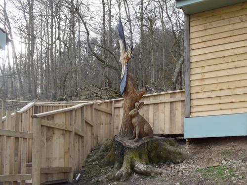 a statue of a tree next to a fence at Red Kite Lodge - Uk32610 in Old Radnor