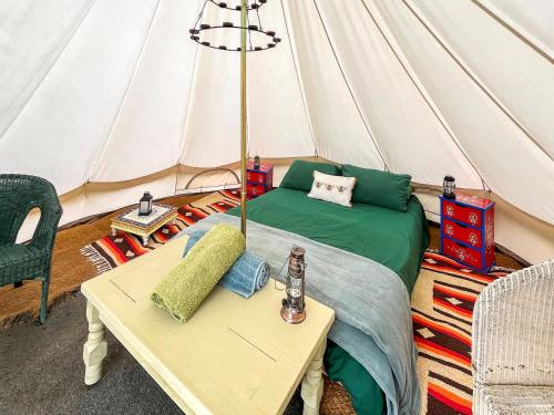 a living room with a tent with a bed and a table at Water Vole - Uk49931 in Shadoxhurst