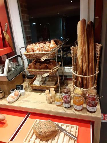 a bakery display with bread and pastries on a counter at ibis les Etangs des Moines in Fourmies