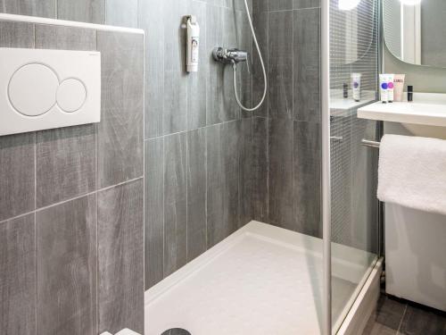 a shower with a glass door in a bathroom at ibis Brignoles Provence Verte in Brignoles