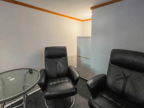 a room with two chairs and a glass table at Seaside in Peacehaven