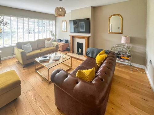 a living room with a couch and a table at Duckling Cottage in Canterbury
