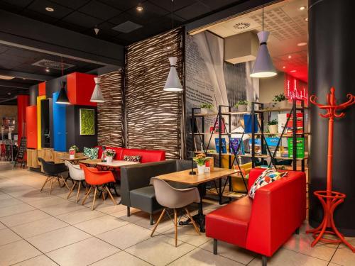 a restaurant with red chairs and tables in a room at ibis Warszawa Centrum in Warsaw