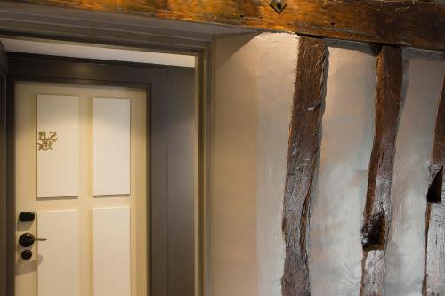 a room with a white door and a wooden wall at Les Tournelles in Paris