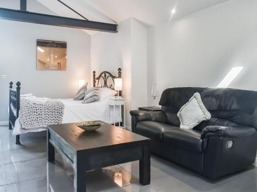 a living room with a couch and a coffee table at Madeline Cottage in Clitheroe