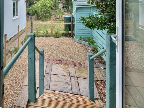 an open door of a house with a wooden gate at Bay Tree in Sturminster Newton