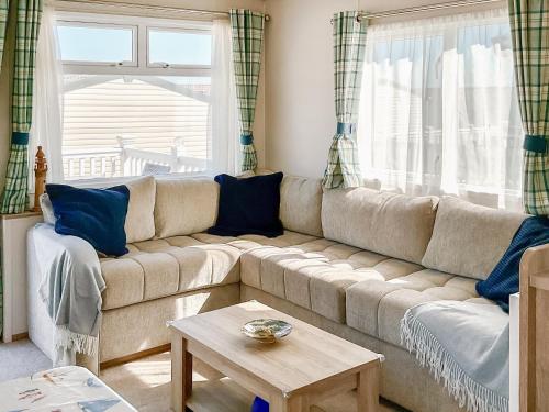 a living room with a couch and a table at Seaside Jollys in Blue Anchor