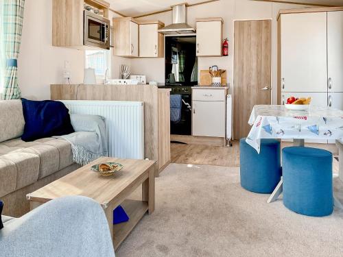 a living room with a couch and a table at Seaside Jollys in Blue Anchor