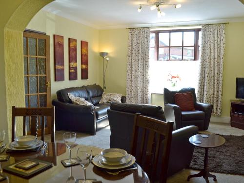 a living room with a couch and a table and chairs at High Bank in Bunbury