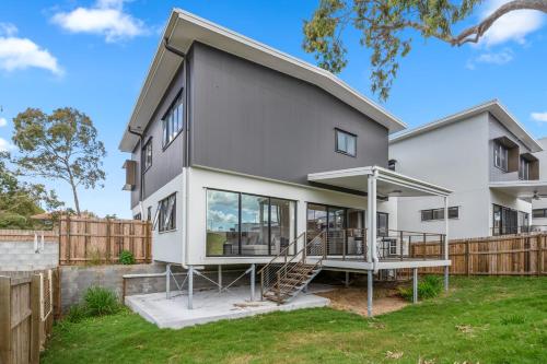 a house being remodeled with a porch and stairs at CASSA AURA PLACE - Modern 4BR Homes in Brisbane