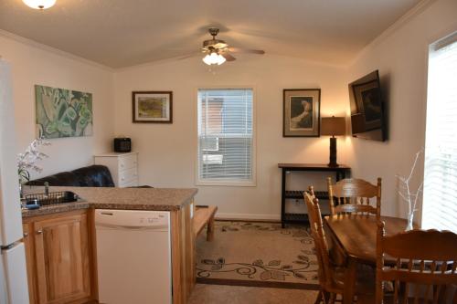 a kitchen and living room with a table and chairs at Cozy Home by Yellowstone River Confluence in Gardiner