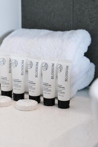 a group of four moisturizers sitting on a counter at CASSA AURA PLACE - Modern 4BR Homes in Brisbane