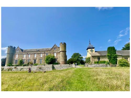 a large castle with a person standing in front of it at Croft Lodge Studio in Leominster