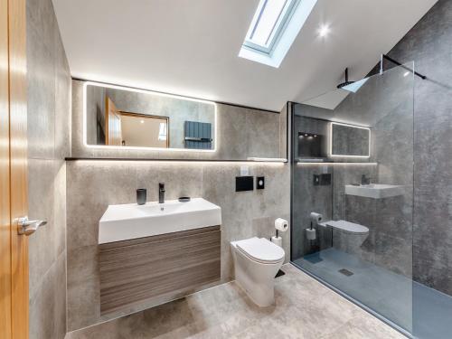 a bathroom with a sink and a toilet and a shower at Garth House - Castlesteads in Brampton