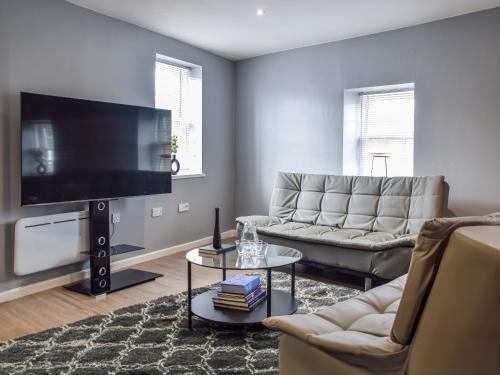 a living room with a large flat screen tv at Apartment 4 - Uk50138 in Stoke on Trent